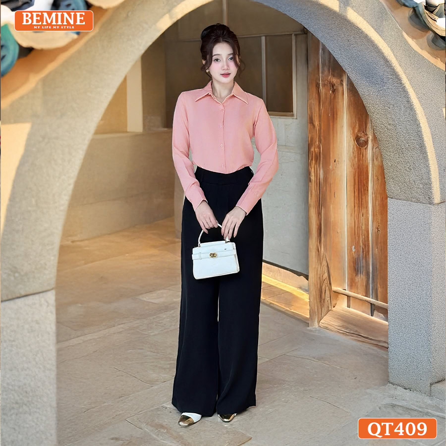 Người mẫu diện quần tây BEMINE QT409 suông dài màu đen phối cùng áo sơ mi chuyên nghiệp.