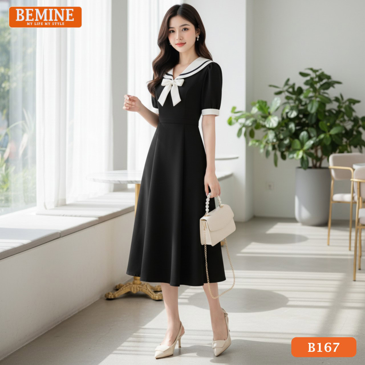 Đầm thiết kế BEMINE cổ thủy thủ phối nơ B167 dáng chữ A phù hợp đi chơi Người mẫu mặc đầm BEMINE B167 dáng chữ A, cổ thủy thủ phối nơ, tạo vẻ ngoài năng động khi đi chơi
