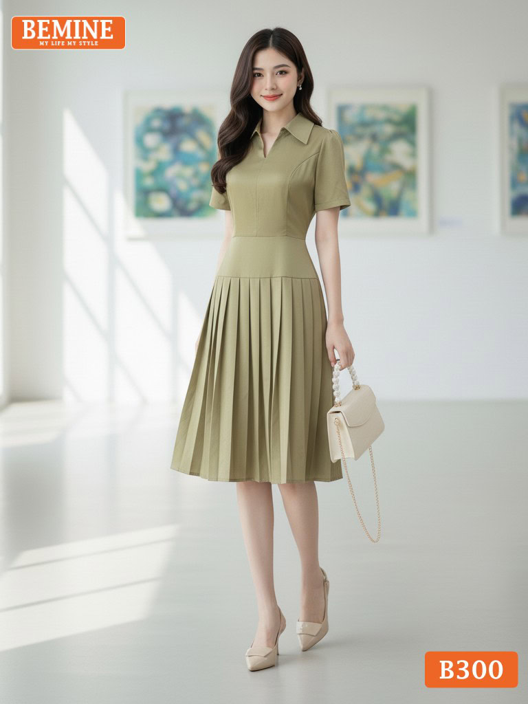 Đầm thiết kế BEMINE B300 cổ sơ mi xẻ V, tùng váy xếp ly tinh tế giúp mỗi bước đi thêm uyển chuyển.